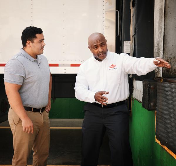 Orkin Pro discussing bird control services with a customer